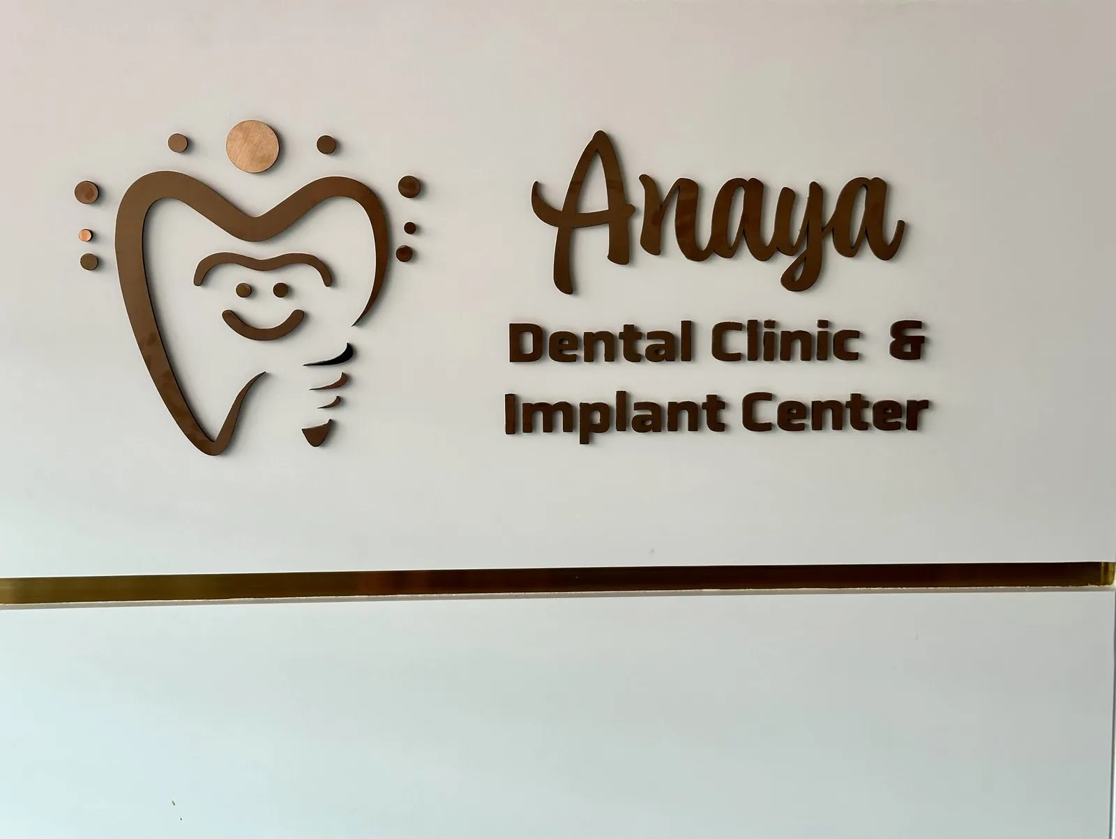 Anaya Dental Clinic & Implant Center logo sign on the clinic wall