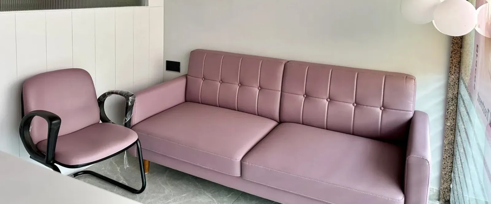 Waiting area with a sofa and chair at the clinic