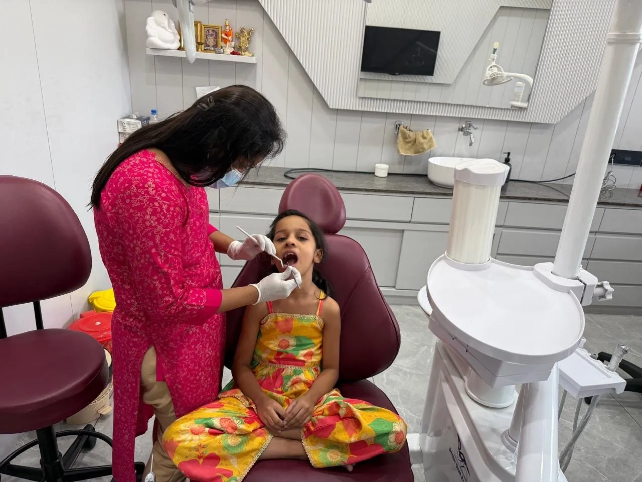 Dr. Rima Shah checking a young girl’s teeth