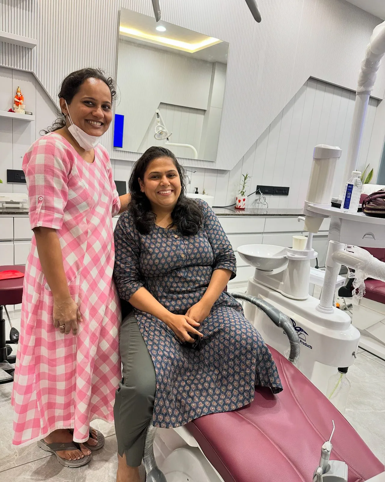 Dr. Rima Shah standing beside a smiling patient at Anaya Dental Clinic